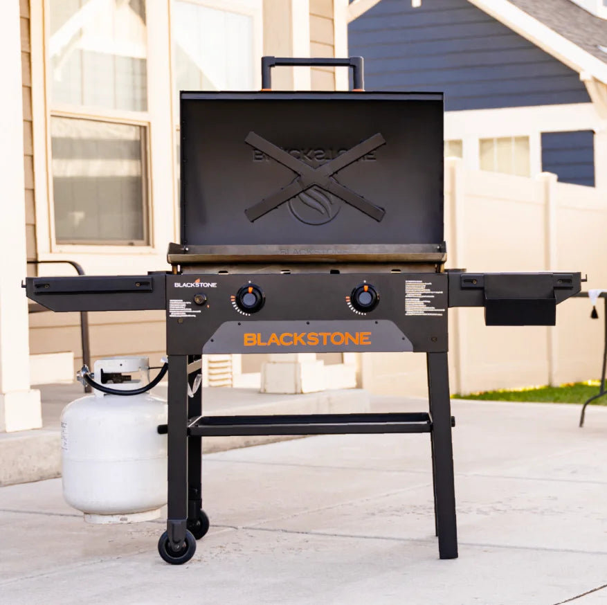 Blackstone Original 28-Inch Griddle with Hood, featuring Omnivore Griddle Plate Technology for even heat distribution and built-in wind guards, includes reinforced hood, dual heat zones, and smart storage solutions.