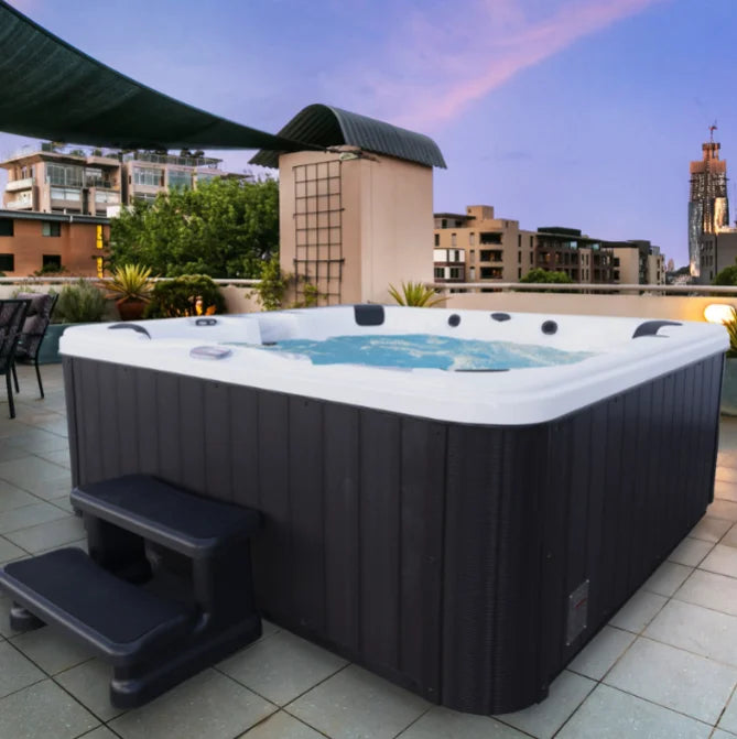 American Spas 6-Person Bench Spa featuring 100 exclusive Halo stainless steel jets for deep hydrotherapy, multi-colored LED lighting, and Bluetooth audio system.
