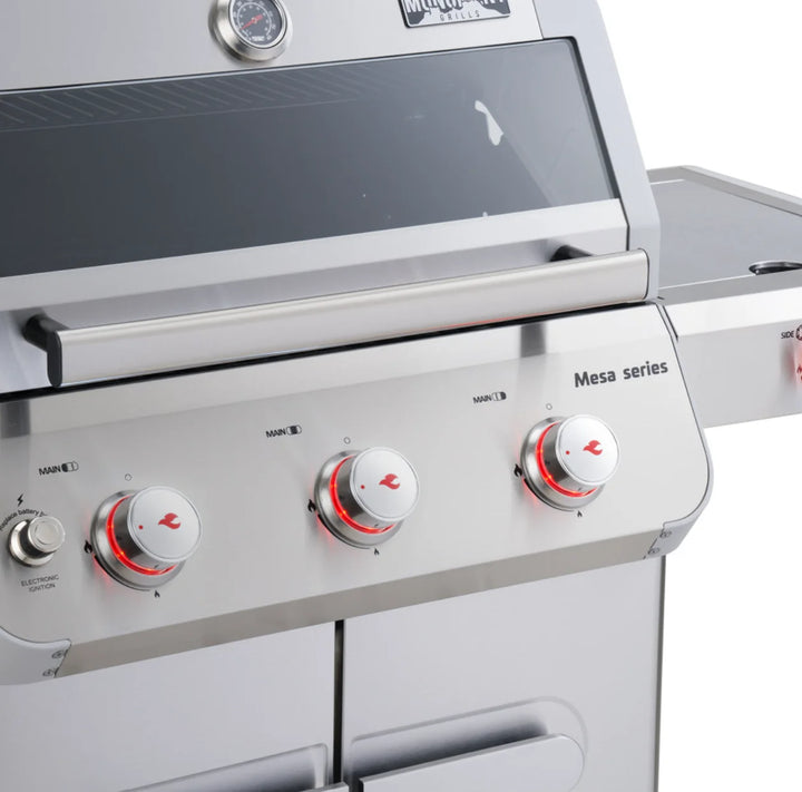 Compact stainless steel propane gas grill, Monument Grills 'M305' Mesa Series, features 3 high-performance burners, porcelain-coated cast iron grates, and sleek design for efficient outdoor cooking.