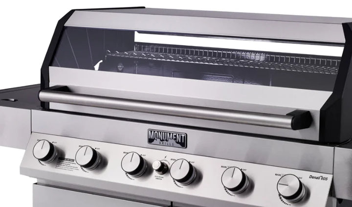Monument Grills Denali Series D605 Gas Grill - Stainless Steel Construction, Six High-Output Burners, ClearView Lid, Digital Touchscreen Interface, and Bluetooth Connectivity for Wireless Monitoring and Control.