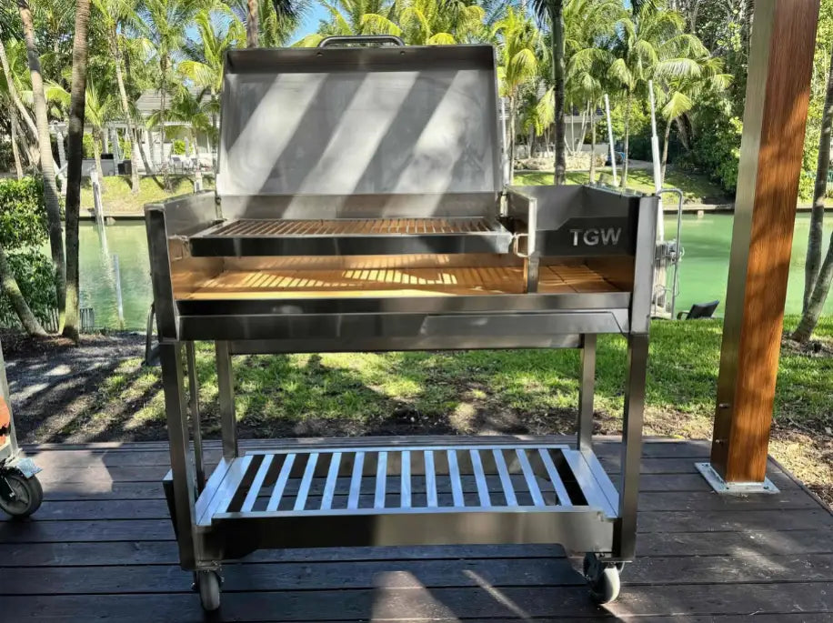 Tagwood Freestanding Santa Maria Style Grill – Stainless Steel: High-quality stainless steel construction, dual preset grate positions, and brasero firebox for precise temperature control over 705 sq. in. cooking surface, perfect for searing steaks, roasting poultry, or smoking vegetables.