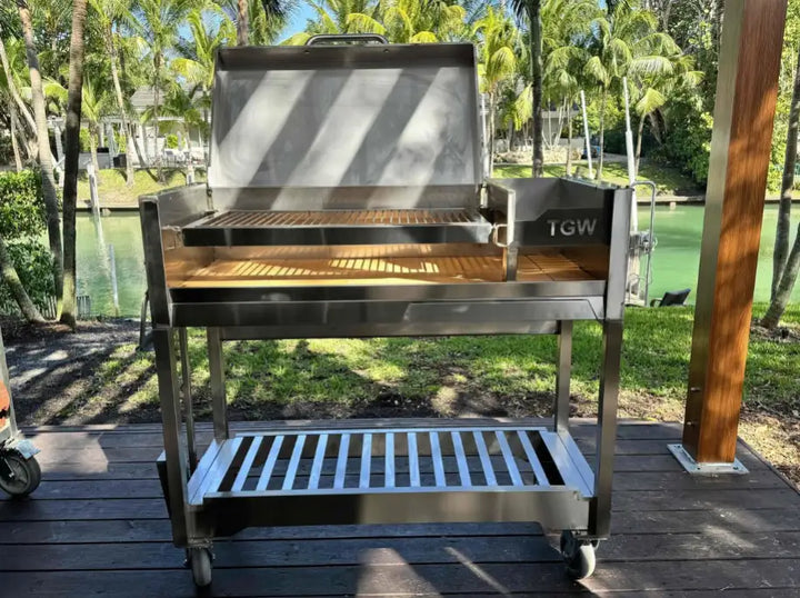 Tagwood Freestanding Santa Maria Style Grill – Stainless Steel: High-quality stainless steel construction, dual preset grate positions, and brasero firebox for precise temperature control over 705 sq. in. cooking surface, perfect for searing steaks, roasting poultry, or smoking vegetables.
