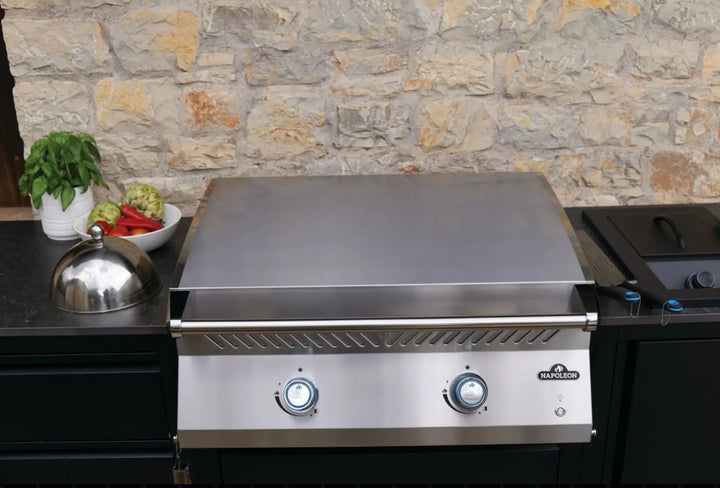 Napoleon Built-In 700 Series 32 Griddle: High-performance cooking griddle with premium 304 stainless steel body, 5mm thick 430 stainless steel cooktop, and dual U-shaped burners delivering 24,000 BTUs across 500 sq.in. of total cooking area.