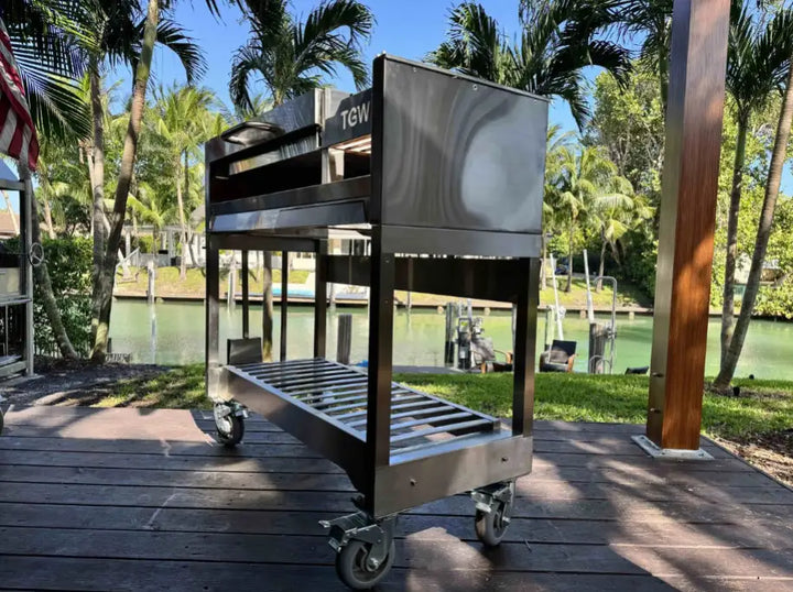 Tagwood Freestanding Santa Maria Style Grill - Stainless Steel: Durable 304 stainless steel construction, premium grilling surface, adjustable grate positions, brasero firebox and firebrick supports for precise temperature control, perfect for Argentine-style live-fire cooking.