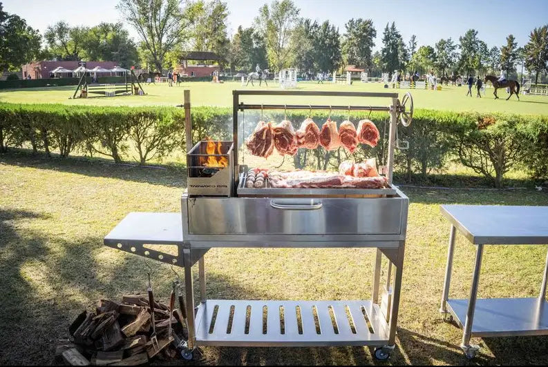 Tagwood BBQ Argentine Santa Maria Wood Fire & Charcoal Gaucho Grill - Stainless steel construction, 4 cooking zones, adjustable main grate, secondary grate, interchangeable griddle, and S-shape meat hooks for authentic Argentine grilling experience.