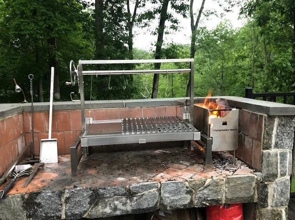 Tagwood Built-in Santa Maria Style Grill (656 sq. in.) features stainless steel construction, insert design for seamless integration, 656 sq. in. grilling space, and hanging area for meats with precise fire control and efficient charcoal management.