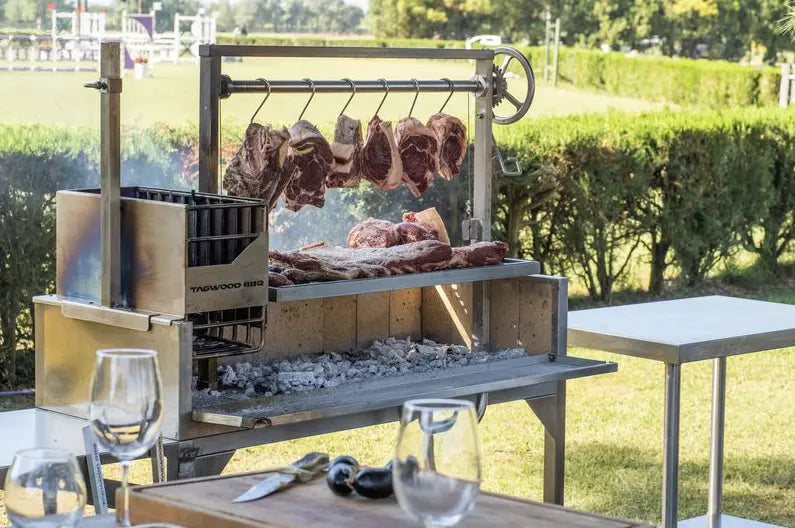 Tagwood BBQ Argentine Santa Maria Wood Fire & Charcoal Gaucho Grill: High-quality #304 stainless steel construction, 710 sq. in. total cooking surface across four distinct zones, featuring interchangeable griddle and S-shape meat hooks for authentic gaucho-style asado.