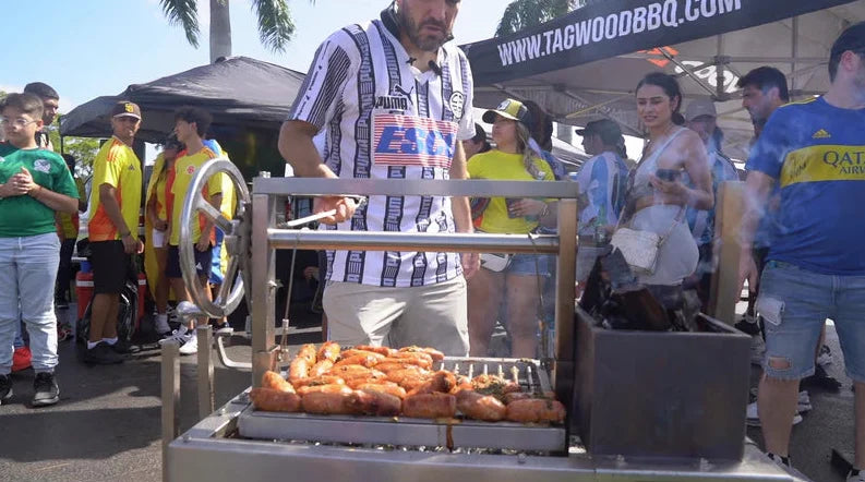 Tagwood Freestanding 'Mini' Santa Maria Style Grill, compact stainless steel grill with four cooking zones, height-adjustable main grate, interchangeable griddle, and gaucho-style brasero firebox.