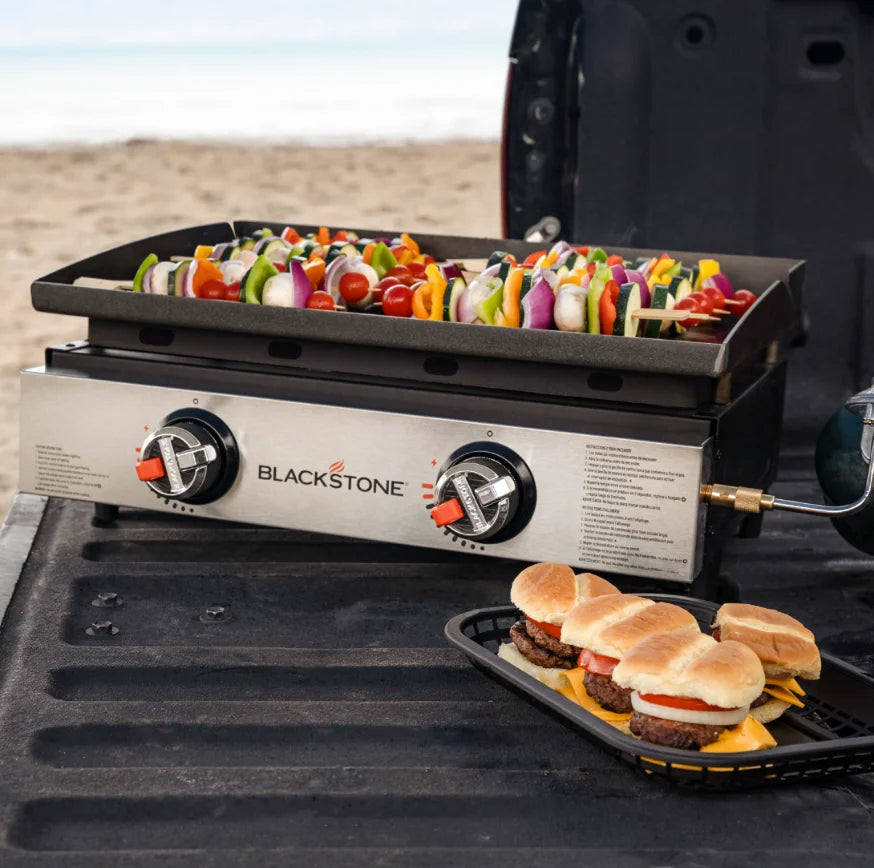 Blackstone Original 22-Inch Tabletop Griddle features Omnivore Griddle Plate for even heat distribution, dual independently controlled heat zones, and stainless steel 'H' burners for reliable performance in outdoor cooking.