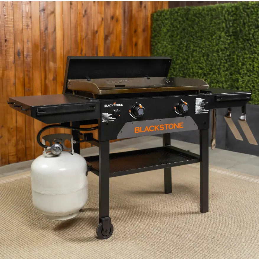 Blackstone Original 28-Inch Griddle with Hard Cover features Omnivore Griddle Plate for efficient cooking, dual heat zones, side shelves, and grease management system, ideal for large gatherings.