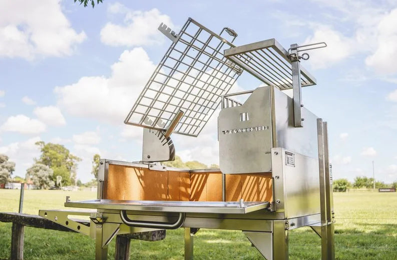 Tagwood Santa Maria Style Clamp Grill with Firebox - High-quality #304 stainless steel construction, features rotating clamp grill for 360° gaucho-style roasting and fixed grill box, secondary grate, and firebrick-lined walls for even heat distribution.