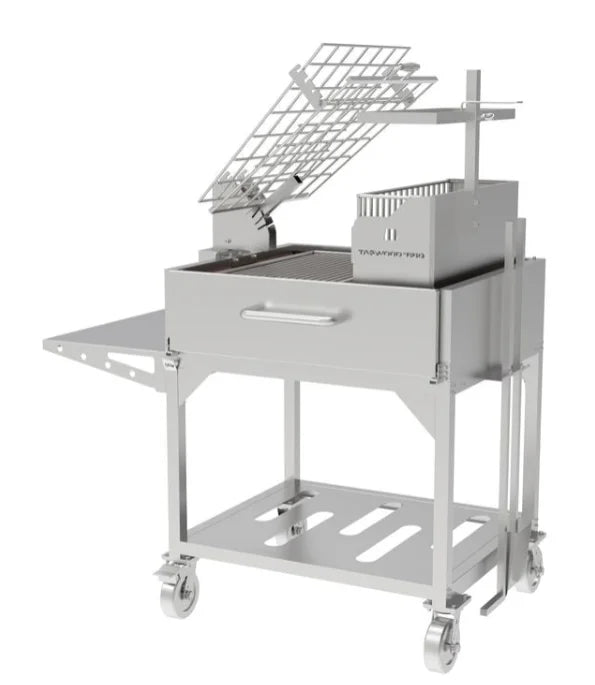 Tagwood Santa Maria Style Clamp Grill with Firebox in stainless steel features rotating clamp grill, fixed grill box, secondary grate, firebrick-lined walls for even heat distribution and durability.
