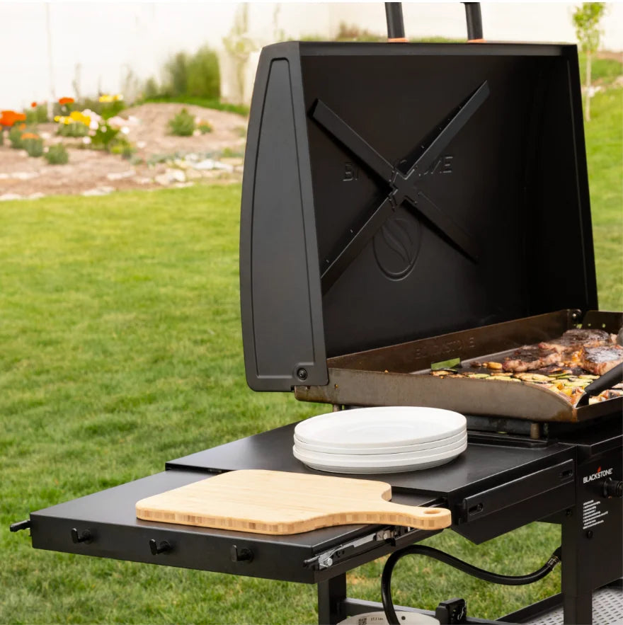 Blackstone Original 36-Inch Griddle with Hood features Omnivore plate technology for efficient heat distribution and wind guards, with four independently controlled heat zones and reinforced hood for consistent performance.