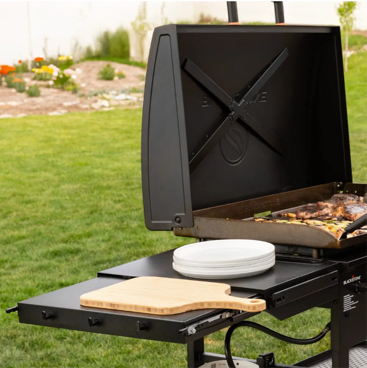 Blackstone Original 36-Inch Griddle with Hood features Omnivore plate technology for efficient heat distribution and wind guards, with four independently controlled heat zones and reinforced hood for consistent performance.