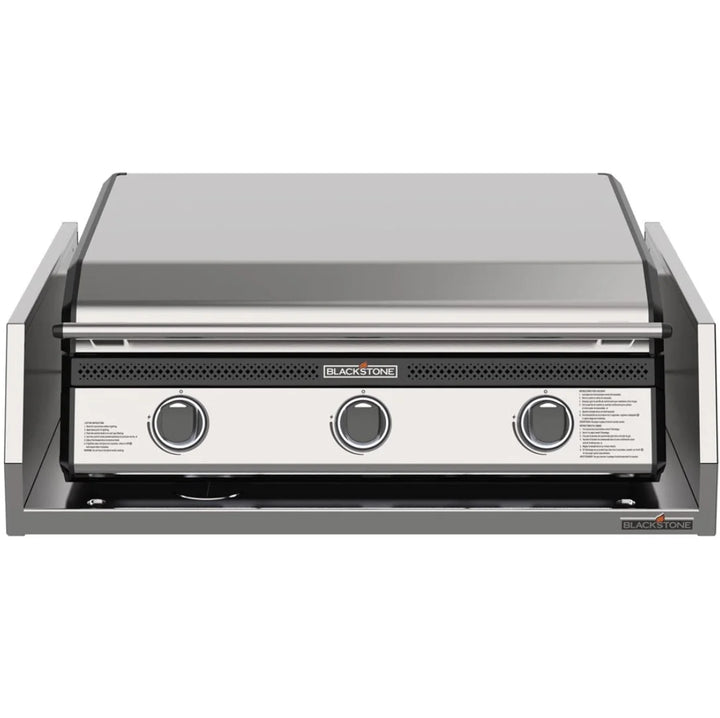 Blackstone 28” Deep Drop-In Griddle with Hood and Insulating Jacket: High-performance outdoor griddle featuring 304-grade stainless steel construction, Omnivore Griddle Plate for rapid heating, three independently controlled heat zones, ambient lighting, built-in hood, and rear grease management system.