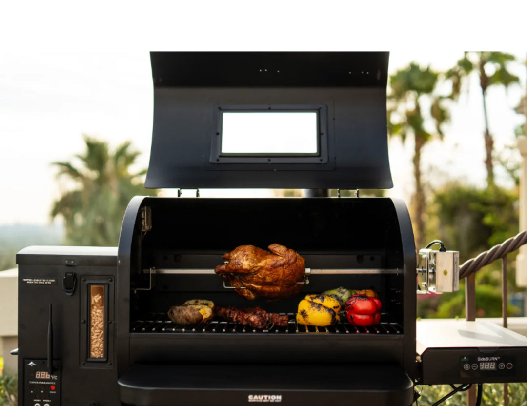 Close-up shot of Ledge PRIME 2.0 WiFi Smart Pellet Grill in a green outdoor setting, highlighting its heavy-gauge steel construction and powder-coat finish.