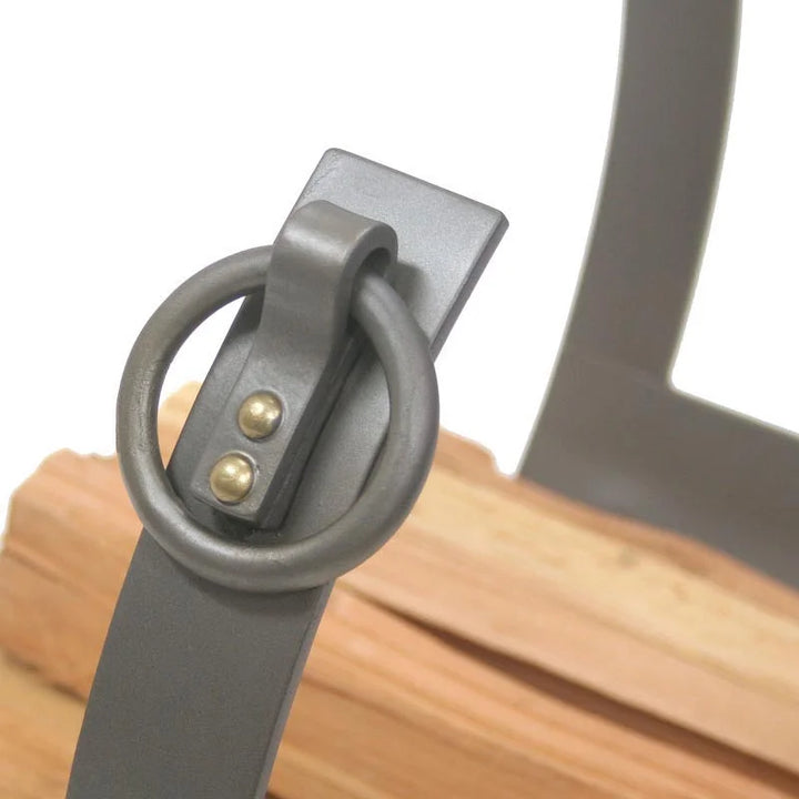 Hand-forged Pilgrim Markham Log Holder in natural iron finish, featuring a sleek steel frame, gentle arches, and ample space for firewood storage beside your hearth or modern stove.