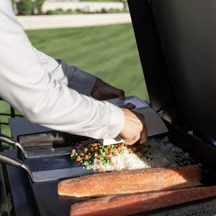 Blackstone 28” Deep Drop-In SS Griddle with Hood - Natural Gas Ready: 304-grade stainless steel construction, Omnivore Griddle Plate Technology, three independently controlled heat zones, built-in hood, and ambient puddle lighting.