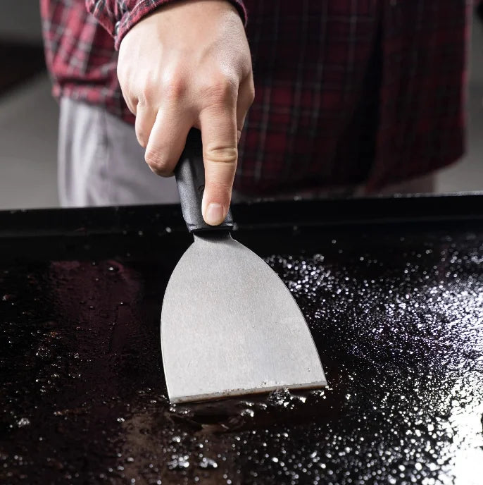 Blackstone 8 Piece Griddle Cleaning Kit featuring scrub pads, griddle bricks, scraper, and tool handles for daily maintenance and long-term care of your cooking surface.