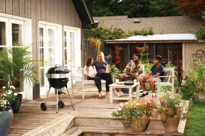 Napoleon Professional 18" Charcoal Kettle features porcelain-coated cast iron cooking grids, three adjustable height settings, and Vortex Heat Management System for consistent convection and precise heat control.
