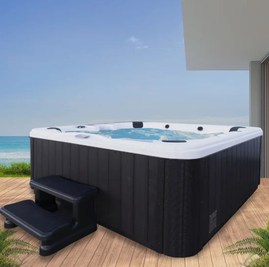 American Spas 6-Person Lounger with 100 Jets: A luxurious spa experience featuring a full-length lounger, 100 exclusive Halo jets, multi-colored LED lighting, and Bluetooth stereo system for ultimate relaxation and entertainment in the backyard.