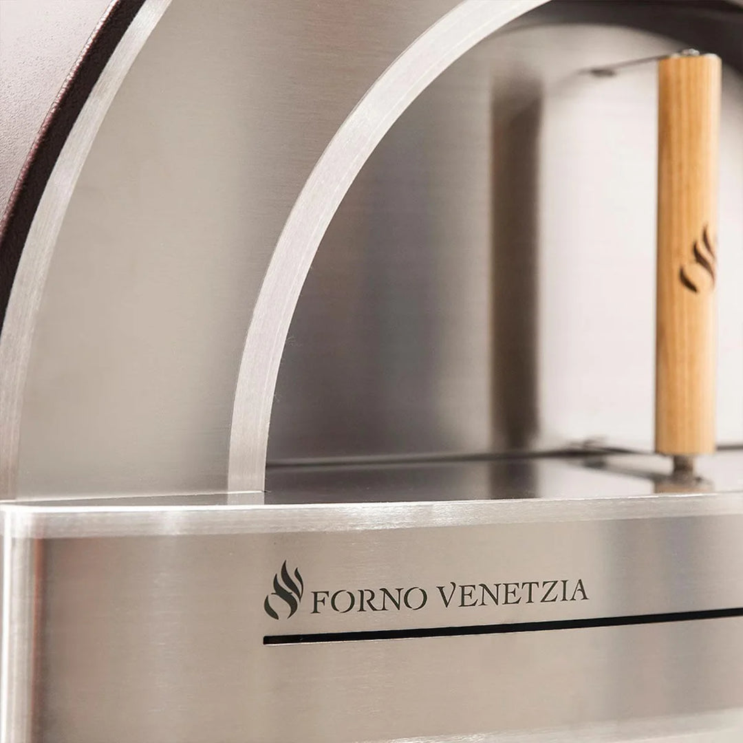 Forno Venetzia "Pronto 220" Copper - Countertop wood-fired oven with 480 sq. in. cooking surface, refractory brick hearth, and ceramic fiber insulation, finished in copper with iconic chimney cap and oak handle.