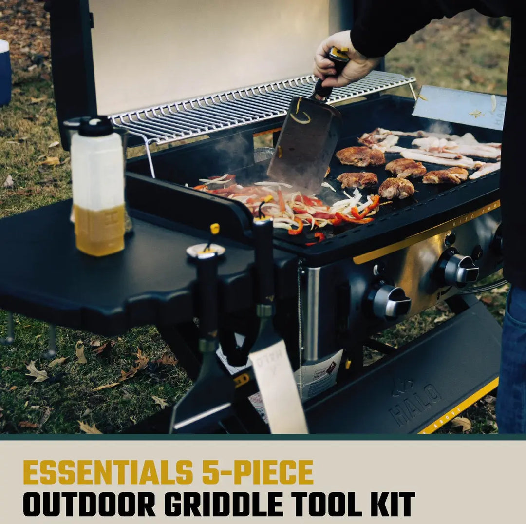 HALO 5-Piece Elite Essentials Griddle Tool Kit featuring stainless steel spatula, scoop spatula, blade spatula, squeegee scraper, and 27 oz squeeze bottle with magnetic handles for griddles.