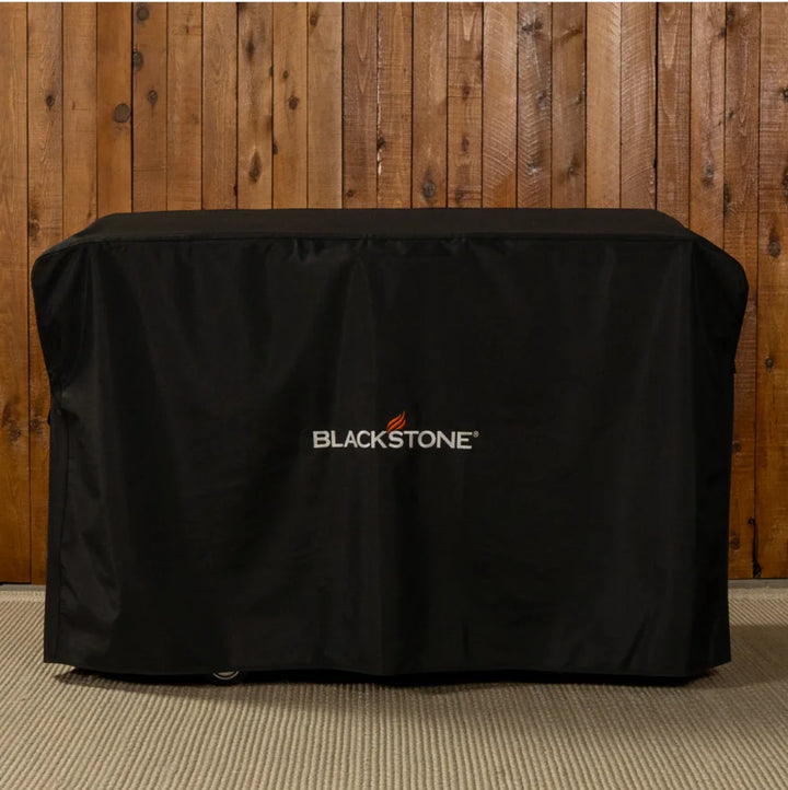 Blackstone 28-Inch Griddle Cover for outdoor protection against dirt, debris, sun, and weather exposure, featuring heavy-duty weather-resistant materials, reinforced stitching, and secure side buckles.
