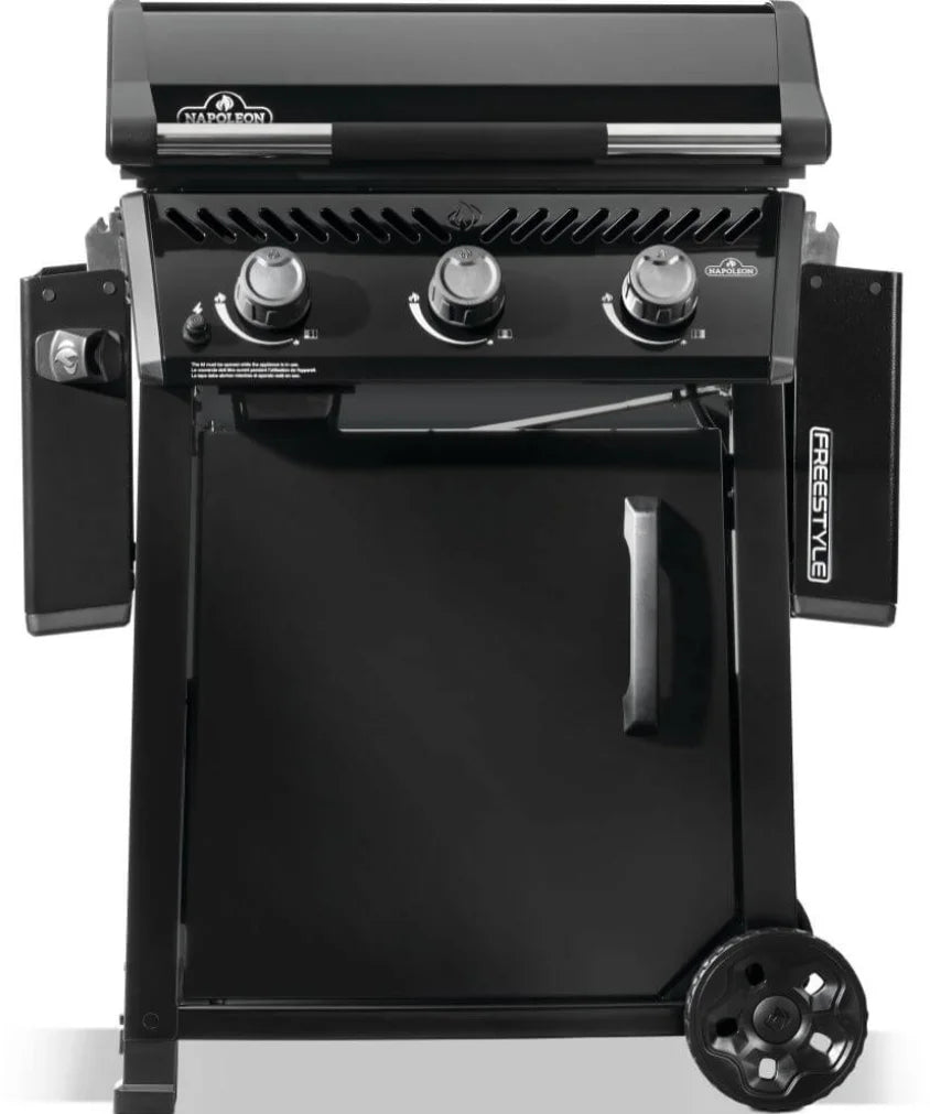 Napoleon 24" Freestyle Non-Stick Griddle featuring a 3.5mm pre-seasoned steel cooktop, three burners, and folding side shelves for convenient outdoor cooking.