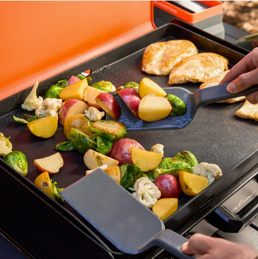 Blackstone OTG Camping Toolkit - A portable all-in-one accessory set for effortless camping cooking, featuring (2) spatulas, (1) scraper, (1) tongs, and (2) 8 oz squeeze bottles with coated-surface compatibility and easy cleanup design.