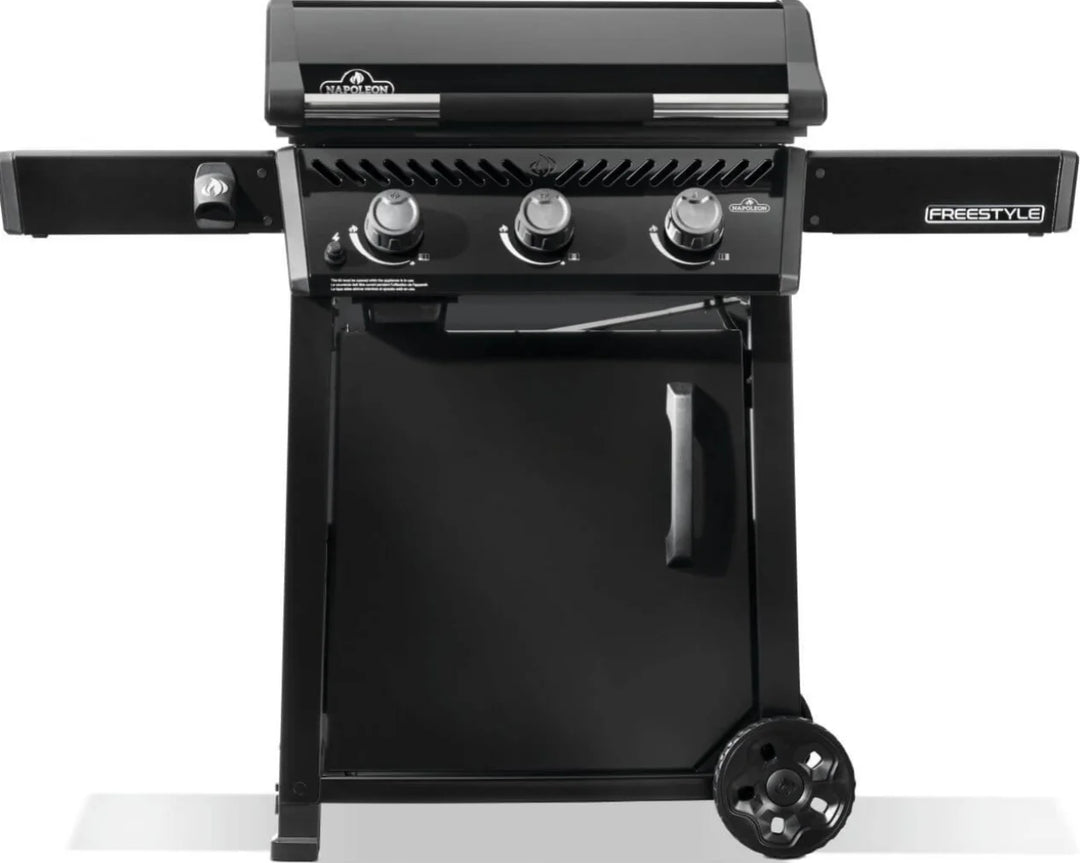 Napoleon 24" Freestyle Non-Stick Griddle features pre-seasoned steel cooktop, three burners producing 25,200 BTUs of heat, and folding side shelves with tool hooks.