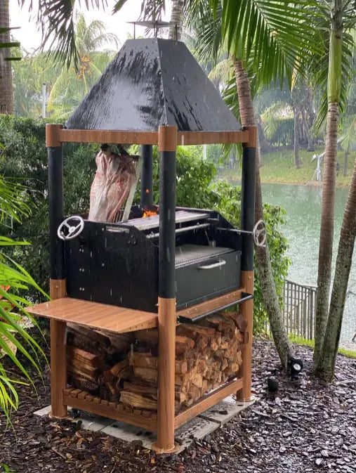 Tagwood "The Beast" Santa Maria Style Grill - Wood & Black: Heavy-duty black cold-rolled steel construction with 304 stainless steel food-contact elements, six distinct cooking zones, including clamp grill, swivel griddle, warming racks, and S-shaped meat hooks, for versatile Argentine-style grilling.