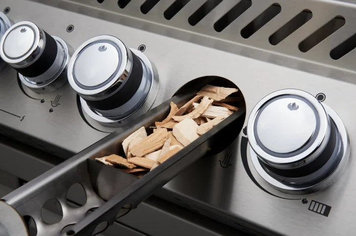 Napoleon Prestige Pro 665 Built-in Gas Grill featuring 9.5-mm stainless steel WAVE cooking grids, infrared rear burner, and RGB Spectrum NIGHT LIGHT control knobs.