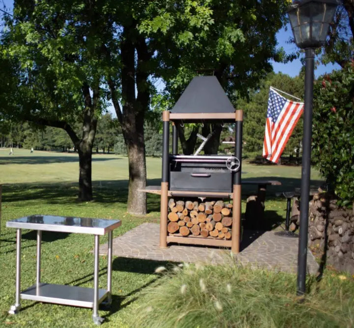 Tagwood 'The Beast' Santa Maria Style Grill - Wood & Black features six cooking zones, including clamp grill, swivel griddle, warming racks, dual height-adjustable grates, and S-shaped meat hooks, with heavy-duty black cold-rolled steel body and premium 304 stainless steel food-contact elements.