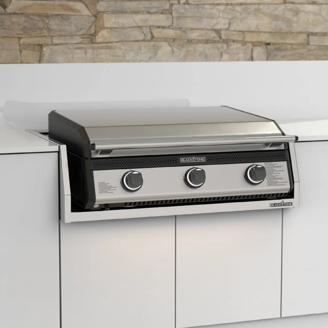 Blackstone 28” Deep Drop-In Griddle with Hood and Insulated Jacket: 304-grade stainless steel construction, Omnivore Griddle Plate for efficient heat distribution, three controlled heat zones, built-in hood, ambient lighting, and safe ignition system.