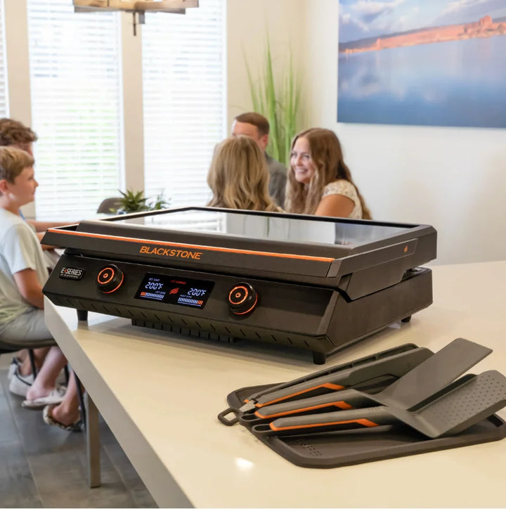Blackstone E-Series 22" Electric Tabletop Griddle: A versatile electric griddle featuring ceramic titanium-coated cooking surface, dual heat zones, removable hood, and LCD display for precision temperature control.