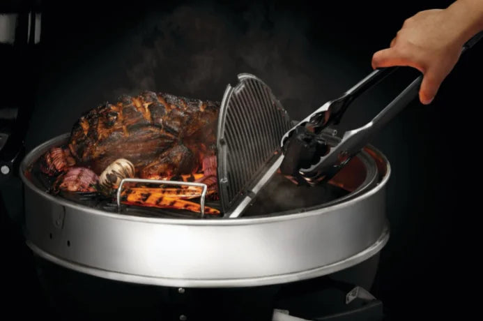 Napoleon Professional 22" Charcoal Kettle features porcelain-coated cast iron cooking grids with three adjustable height settings and Vortex Heat Management System for precision heat control.