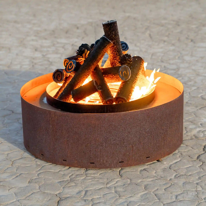 Orion Fire Sculpture - The Outdoor Plus: A circular fire feature with decorative log center and smooth base, offering a warm and modern outdoor centerpiece.