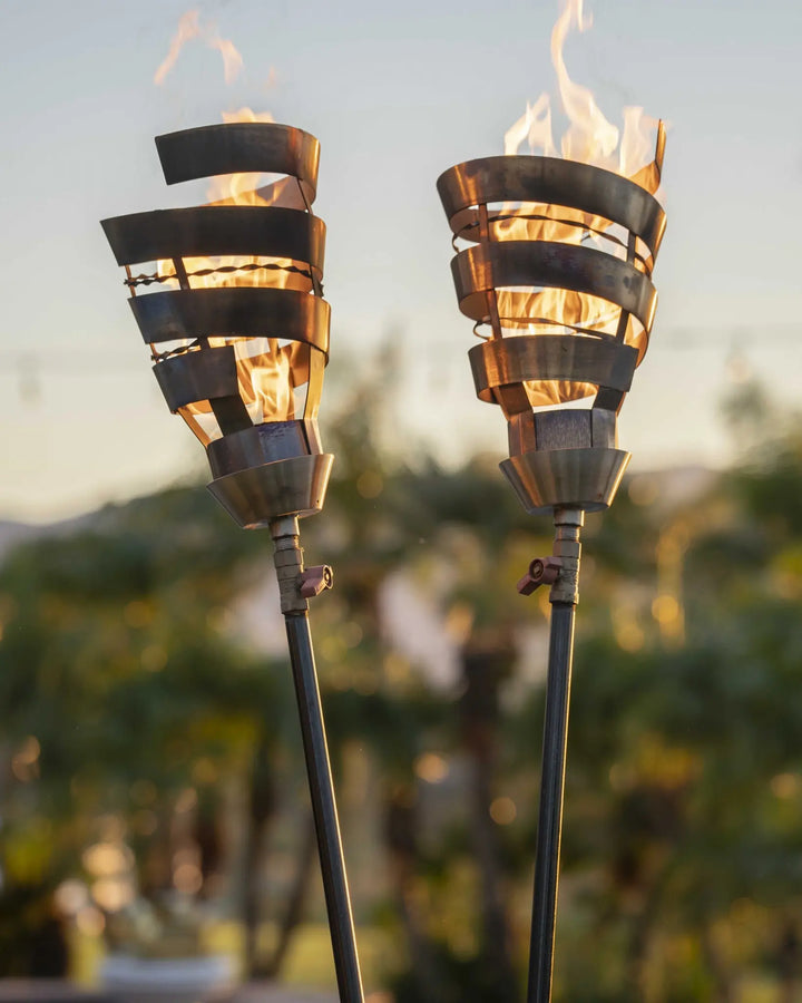 Spiral Fire Torch by The Outdoor Plus, featuring a 3 ¾″ diameter, 14″ tall, 20,000 BTU stainless steel torch head and base for outdoor use.