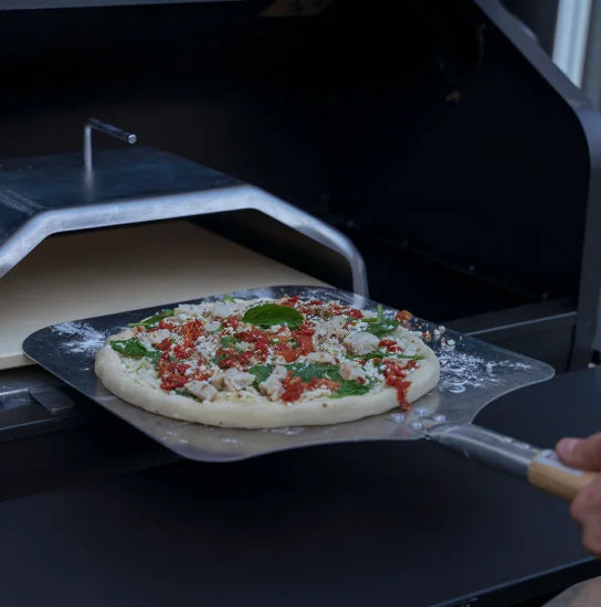 Large Pizza Peel by Green Mountain Grills, lightweight metal peel with GMG-engraved wooden handle for effortless pizza transfer and baking.