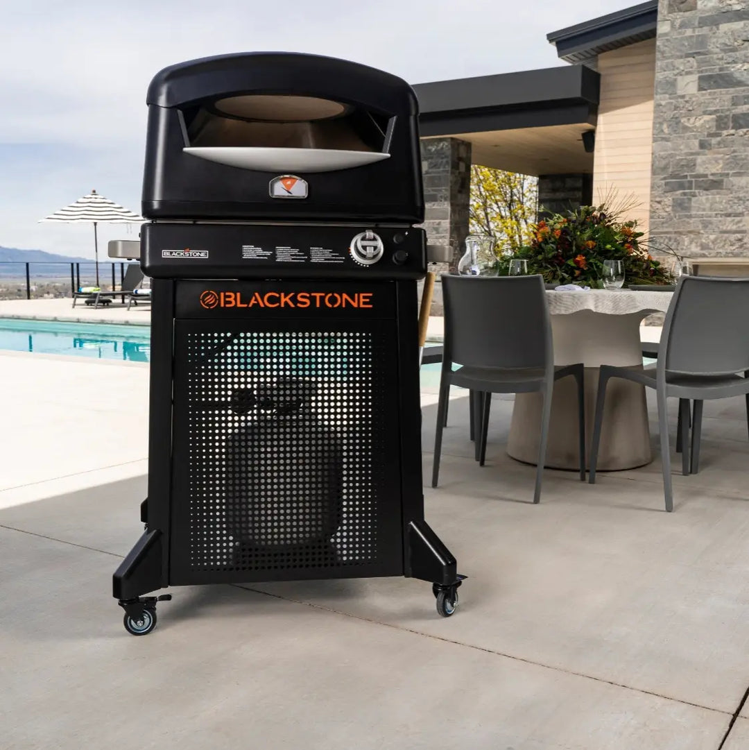 Blackstone Pizza Oven with Stand features patented two-stone technology for even heat distribution and hassle-free pizza rotation, reaching over 900°F in as little as 90 seconds to cook authentic, crispy pizzas outdoors.