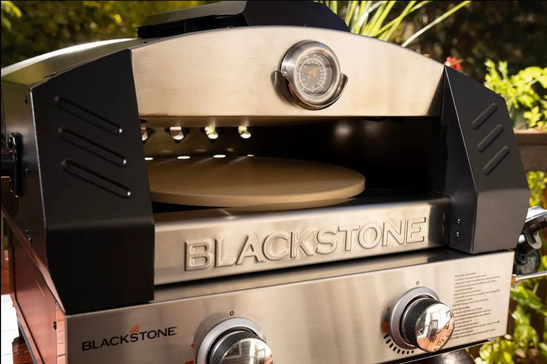 Blackstone Portable Pizza Oven Bundle: Compact propane-powered oven featuring patented 2-Stone Technology for consistent heat, includes cordierite stones, pizza peel, and rocking cutter, ideal for outdoor cooking and entertaining.