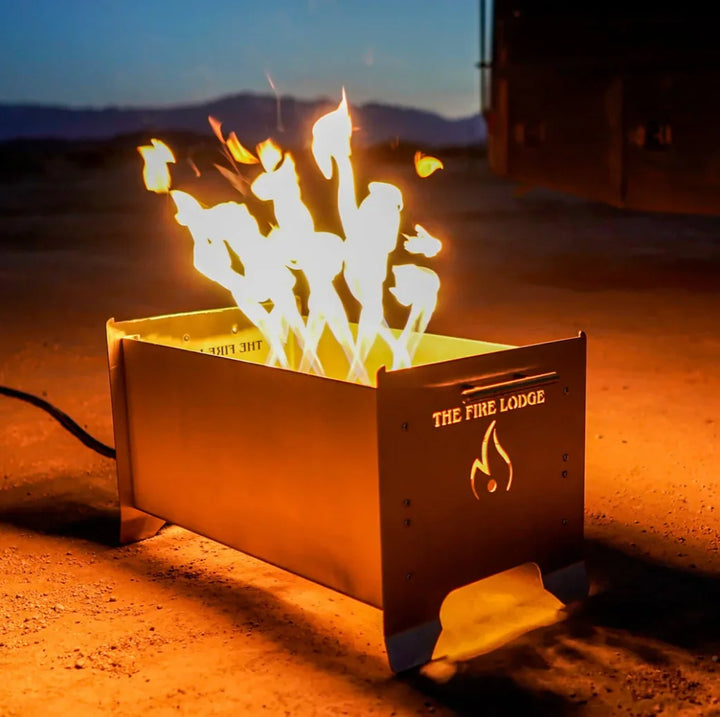 The Videl USA The Overlander - Burning Grill, a ruggedly compact and portable stainless steel grill and fire pit combo, featuring The Fire Lodge's patented Bullet Burner for high-performance flames, proudly Made in the U.S.A.