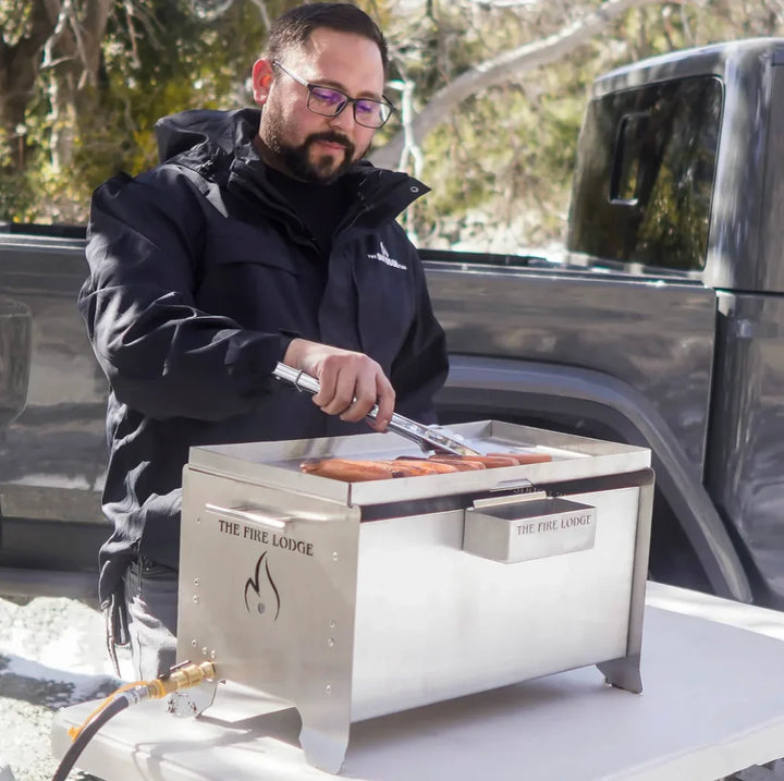 The Videl USA Burning Grill - The Overlander, a rugged portable firepit and BBQ combo crafted from durable 316 stainless steel, featuring the patented Bullet Burner for efficient flame production and resistant to any environment.
