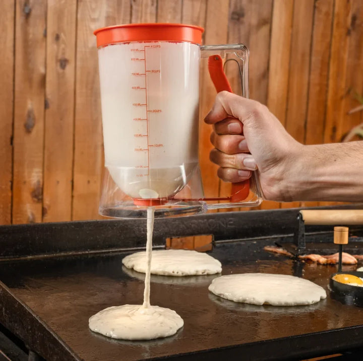 Blackstone Breakfast Kit featuring pre-seasoned cast iron bacon press, batter dispenser holding up to 4 cups, and perfectly round egg rings for uniform cooking results.