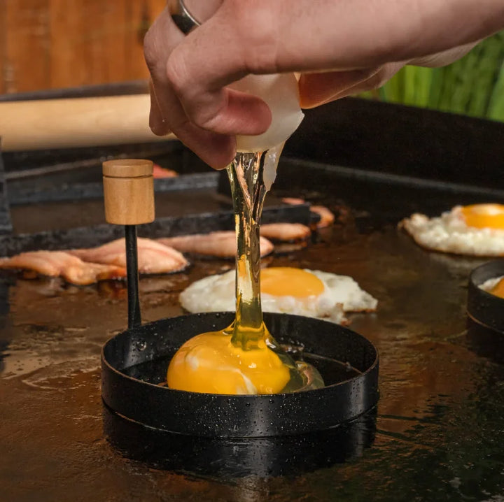 Blackstone Breakfast Kit, includes batter dispenser for up to four cups, cast iron bacon press, and round egg rings for perfect breakfasts.