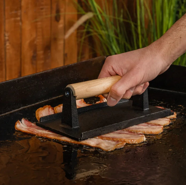 Blackstone Breakfast Kit featuring a pre-seasoned cast iron bacon press, round egg rings, and easy-to-use batter dispenser for precise pouring, ideal for pancakes, cupcakes, muffins, eggs, or sandwiches.