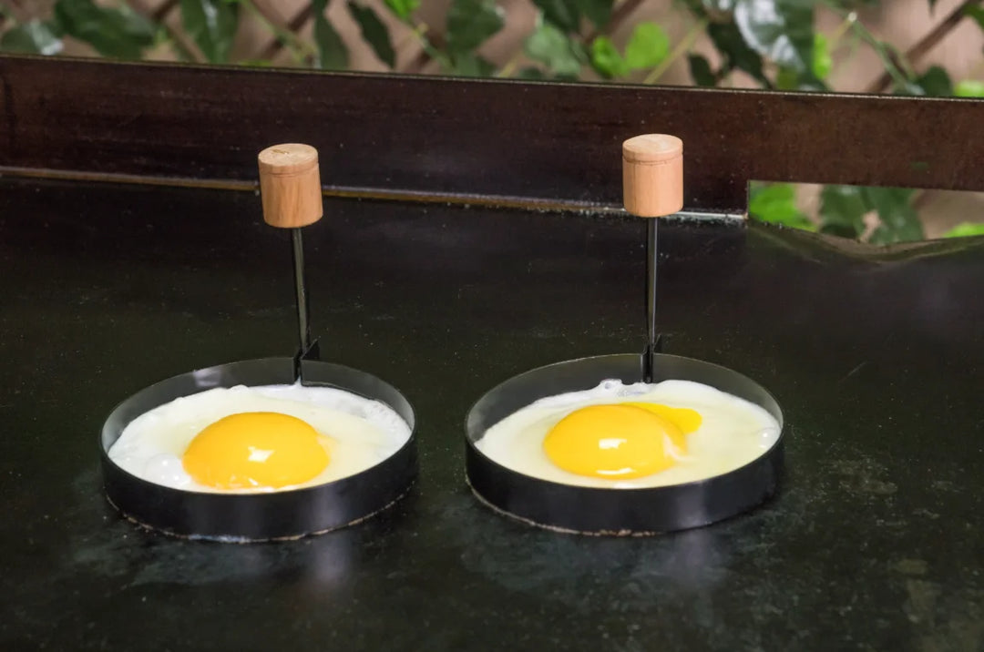 Blackstone Breakfast Kit featuring pre-seasoned cast iron bacon press, batter dispenser for up to four cups, and perfectly round egg rings.