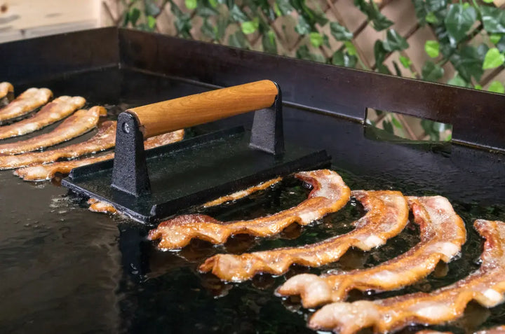 Blackstone Breakfast Kit, complete griddle breakfast set with batter dispenser, cast iron bacon press, and round egg rings for uniform cooking results.