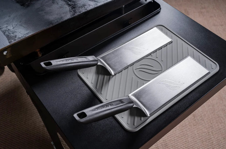 Blackstone Deluxe Spatula 2 pc Set features heavy-duty stainless-steel construction, heat-resistant handles, and beveled edges for precise food handling, perfect for outdoor cooking.